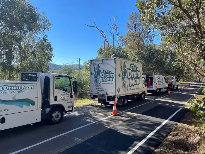Drain Man commercial trucks and vans at a roadside job